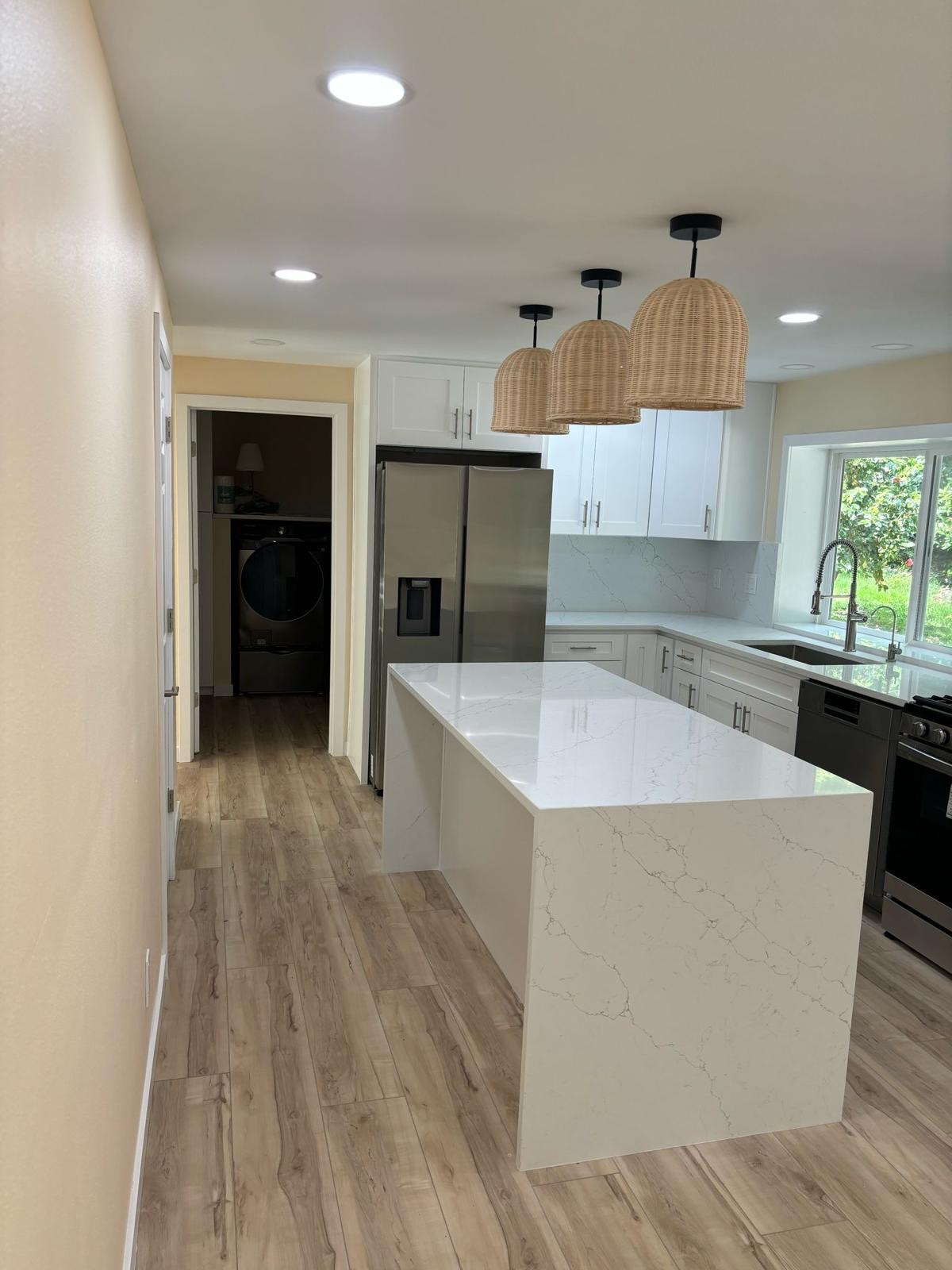 Kitchen lighting installation with under-cabinet LEDs and pendant fixtures in Seattle remodel
